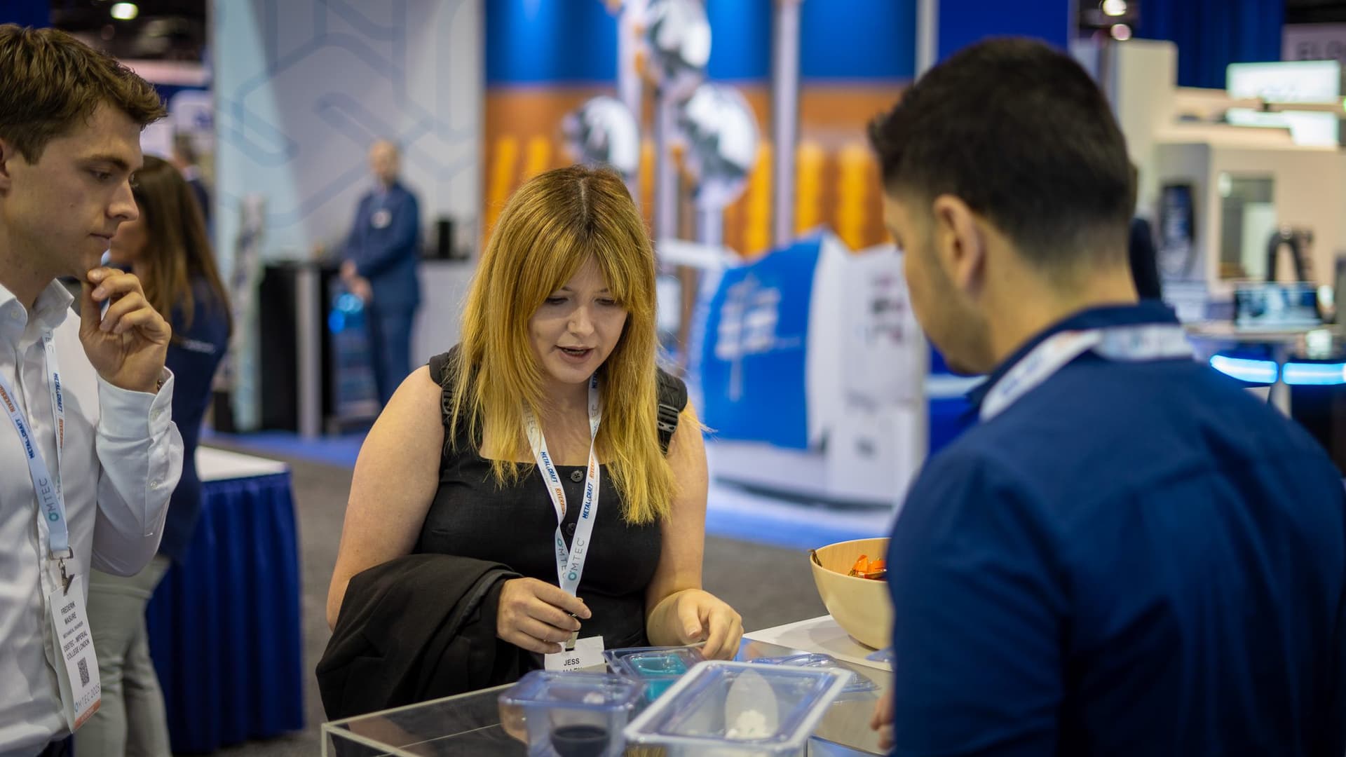 OMTEC 2025 Booth Visitor Interaction